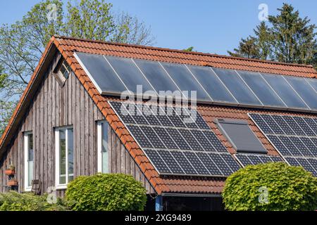 solar panels on the roof of a wooden house Stock Photo