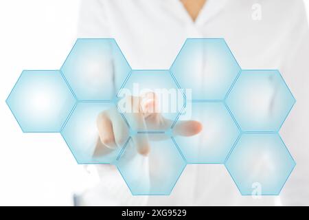 Person touching an hexagonal button on a digital interface Stock Photo