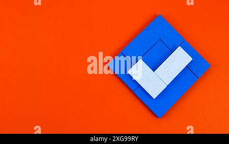 White check mark on blue box formed with wooden pieces Stock Photo
