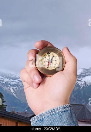 Man using compass in mountains, closeup. Navigational instrument Stock Photo