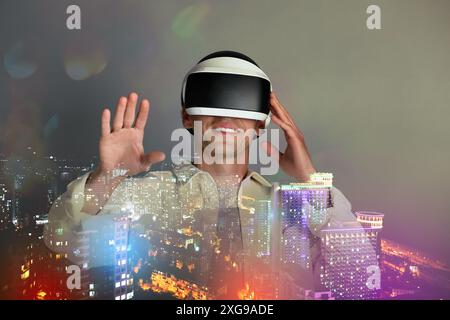 Developer using virtual reality headset in project. Modern technology. Double exposure of man and cityscape Stock Photo