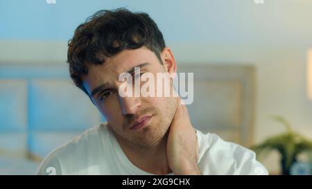 Close up young Caucasian European tired man bored fatigue burnout yawn unhappy boredom exhausted sleepy overwork face lazy portrait melancholy pensive Stock Photo
