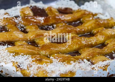 close up of a quince pastafrola type cake decorated with grated coconut Stock Photo