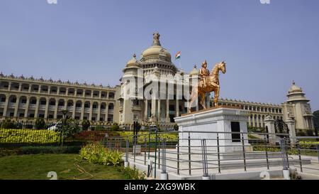 Bangalore, India - January 16 2024: Kempe Gowda statue in front of famous stunning Vidhana Soudha. Stock Photo