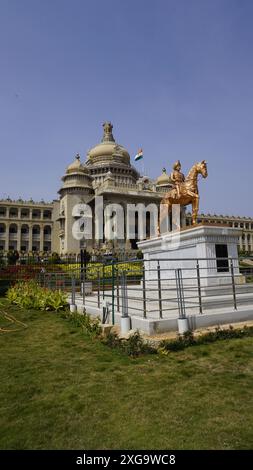 Bangalore, India - January 16 2024: Kempe Gowda statue in front of famous stunning Vidhana Soudha. Stock Photo