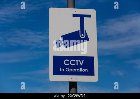 Signboard of CCTV in operation, against the blue sky. Singapore Stock Photo