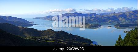 Panoramic View of beautiful  Lyttelton Harbour on a perfect Winter Day with reflections from islands, New Zealand. Stock Photo