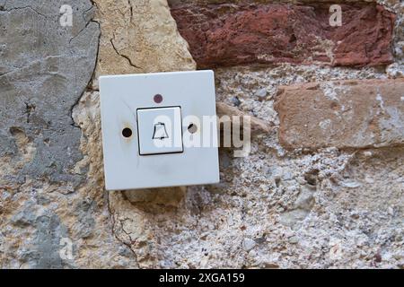 Old doorbell button at the entrance of an old house in the old town centre of Krk in Croatia Stock Photo