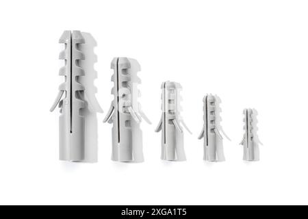 Group of Plastic dowels isolated on a white background. Wall plugs in different sizes Stock Photo