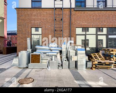 old building renovation and upgrading. air pipes and fittings, parts of the air conditioning system before installation. Stock Photo