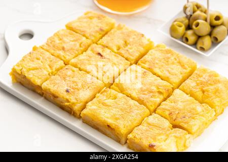 Spanish potato omelette appetizer called spanish tortilla on marble table. Typical spanish tapa Stock Photo