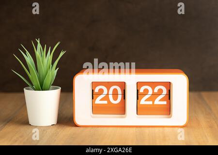 Retro Flip clock with 2022 number on wooden table. New year concept. Copy space Stock Photo