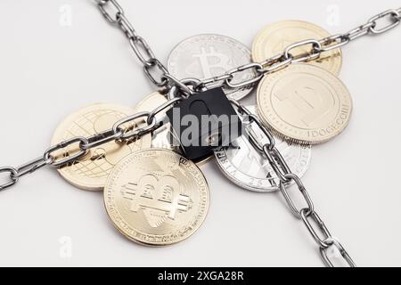 Cryptocurrency security concept. Group of crypto coin protected by chain and padlock Stock Photo