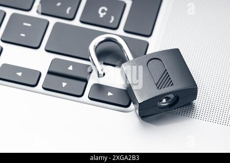 Open padlock on modern laptop. Computer Security Vulnerability concept Stock Photo