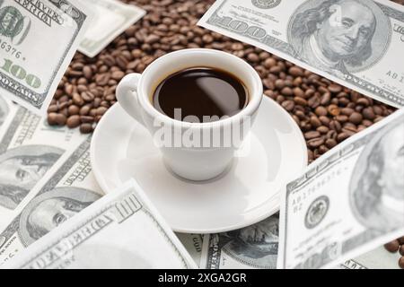 Cup of coffee on Coffee beans and dollar banknotes flying around it. Rising coffee prices concept Stock Photo