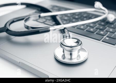 Computer diagnose concept. Stethoscope on modern laptop computer Stock Photo