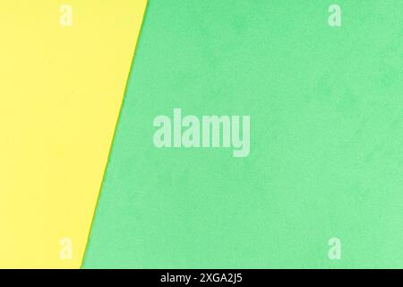 Yellow and green foam sheet with diagonal texture background. Full frame Stock Photo