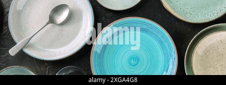 Modern tableware panorama with a blue plate. Elegant catering panoramic banner, shot from above on a black background Stock Photo