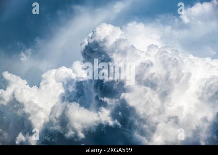 Dramatic sky, light from heaven. (Cumulus) stormy clouds in summer. Background Stock Photo