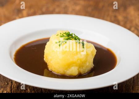 Bavarian dumpling in a plate with sauce Stock Photo