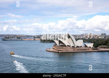 Sydney harbour, Royal Australian Naval vessel HMAS Canberra in Garden Island and Sydney Opera house building, New South Wales,Australia Stock Photo