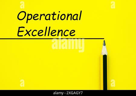 Operational Excellence text on yellow cover background with straight line and pencil background. Stock Photo