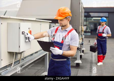 Electrician engineer or technician checking the condition of ventilation system. Stock Photo