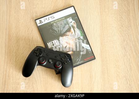 KYIV, UKRAINE - JUNE 26, 2024 Metal Gear Solid Delta Snake Eater PS5 video game disc box for console gaming. Popular video game disc close up Stock Photo