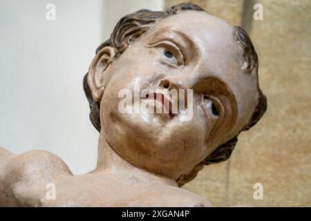 Carved sculpture of rococo cherub in a detail Stock Photo