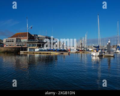 Royal Lymington Yacht Club and marina with the Wight Link ferries beyond, Lymington Harbour, Lymington, New Forest National Park, Hampshire, England, Stock Photo