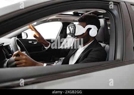 Businessman exploring new car interior using virtual reality headset Stock Photo