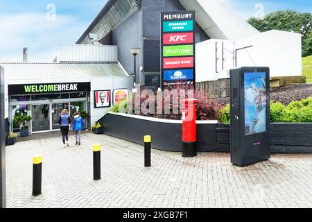 Travellers back view entrance to Welcome Break Services at Membury on M4 motorway road located on old RAF Membury site Lambourn Berkshire England UK Stock Photo