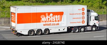 whistl post mail a delivery company business advertising on side view hgv lorry truck & rigid semi trailer driving on M25 motorway in Essex England UK Stock Photo