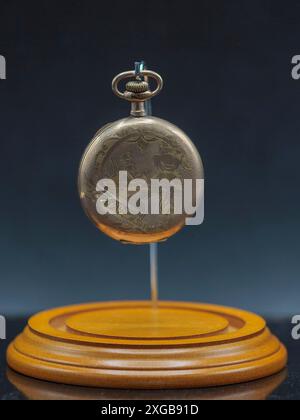 old gold pocket watch a family heirloom from an unclear lineage ago in its display case without the dome Stock Photo