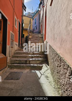 Steep staircase in alley of Vernazza, Cinque Terre, Italy. Colorful buildings. Vertical photo. Stock Photo