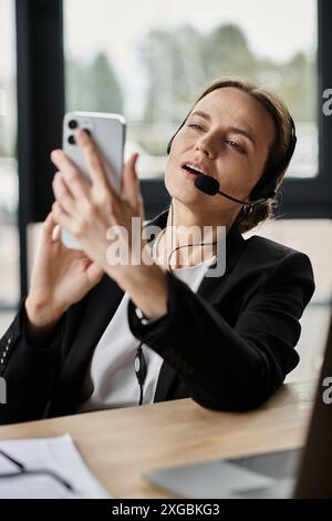 Woman in headset snaps a picture with her phone. Stock Photo