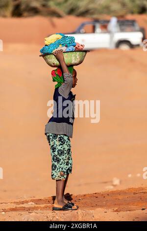 Woman is washing Clothes in the Sahara Desert of Algeria Stock Photo