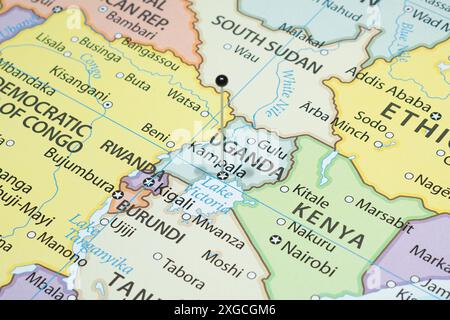 Close up to a Kampala with a black pin needle into Uganda country political map Stock Photo