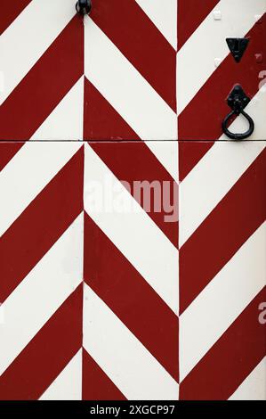 Wooden gate at a castle in the Netherlands with red and white pattern going up and down Stock Photo