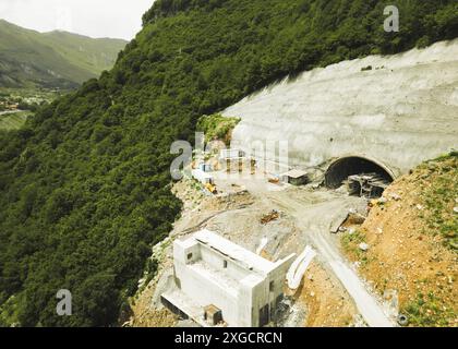 Kazbegi, Georgia - 7th july, 2024: aerial view cranes and bridge foundation pillars on construction site of new highway road project built by chinese Stock Photo