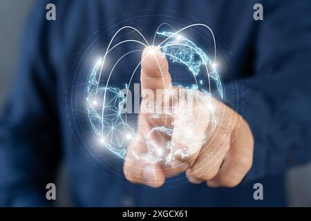 Hand pushing an earth button on the touch screen interface with the black background. Businessman on blurred background using digital triangle explodi Stock Photo