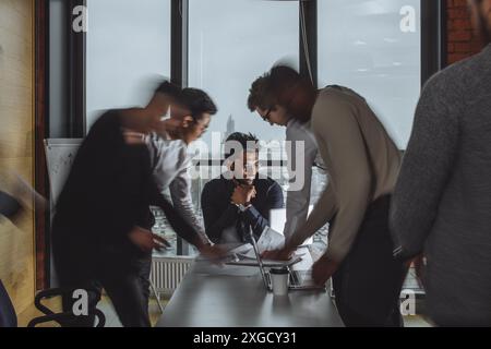 Team work process. Photo young business crew working with new startup project laptop. Project managers meeting. Analyze plans, papers. Blurred backgro Stock Photo