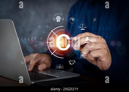Copyright or patent concept, Person hand using laptop computer on desk with VR screen copyright icon background, Copyleft trademark license, Creation Stock Photo