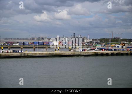 Shipping containers and vehicles on the dockside in the port of Zeebrugge. Stock Photo