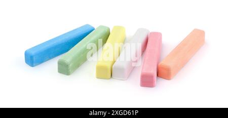 Group of new colorful chalk pieces isolated on white. Stock Photo