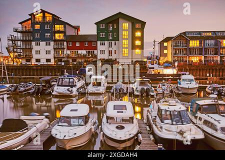 A dusk view of the marina (harbour) and adjacent apartments at Exmouth, east Devon, England, United Kingdom, Europe Stock Photo