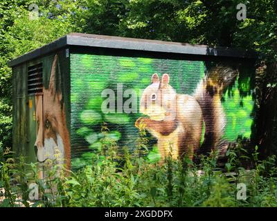 Beautiful graffiti of a squirrel and fox on a small power house Stock Photo