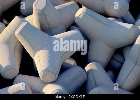 Close up of a cluster of concrete breakwater blocks in random juxtaposition protecting the seawall at Tangeria, April 2024. Stock Photo