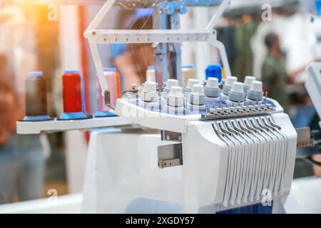 Threads on a sewing machine in loops from spools during automatic operation Stock Photo
