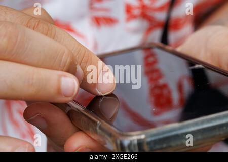 Human fingers of unrecognizable person using technology on mobile phone Stock Photo